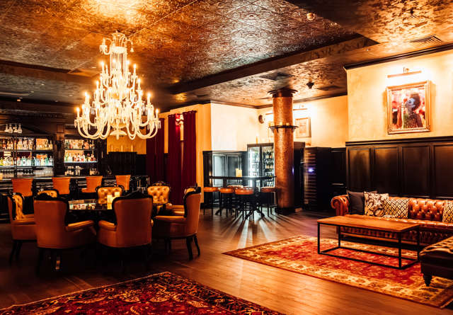 Elegant lounge and bar area with warm ambient lighting and comfortable seating at Virgin Hotels.