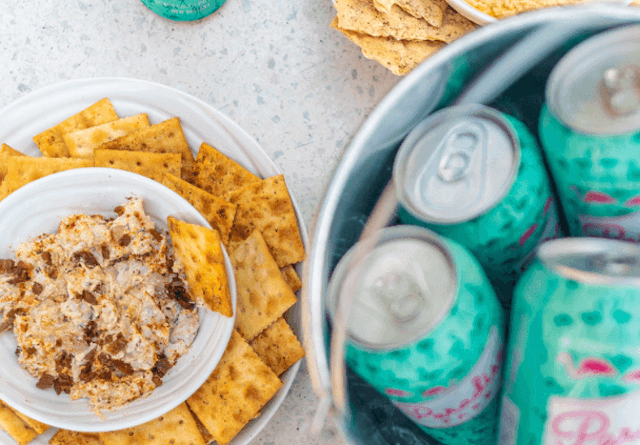 Plate of crackers and dip with an assortment of refreshments at Virgin Hotels New Orleans.