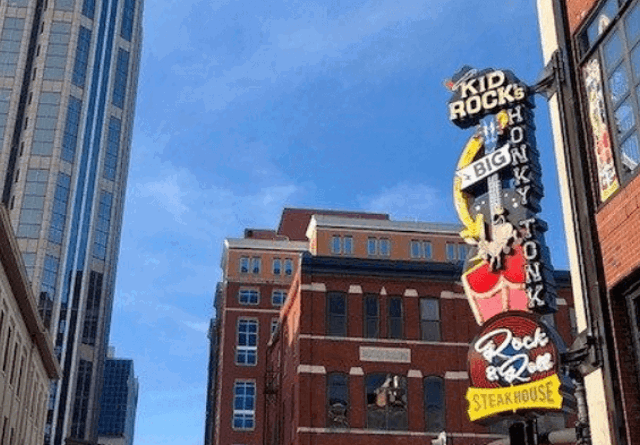A vibrant daytime city skyline featuring modern skyscrapers and urban architecture under a clear, bright sky.