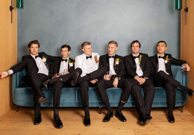 Party of grooms sitting on sofa at Virgin Hotels Nashville.