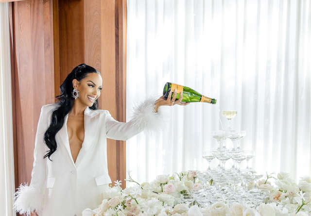 Bride pouring champagne into a fountain at Virgin Hotels, capturing a celebratory moment.