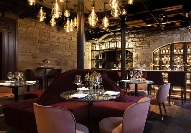 Commons Club Restaurant at Virgin Hotels Edinburgh, featuring elegant dining setup and modern decor.